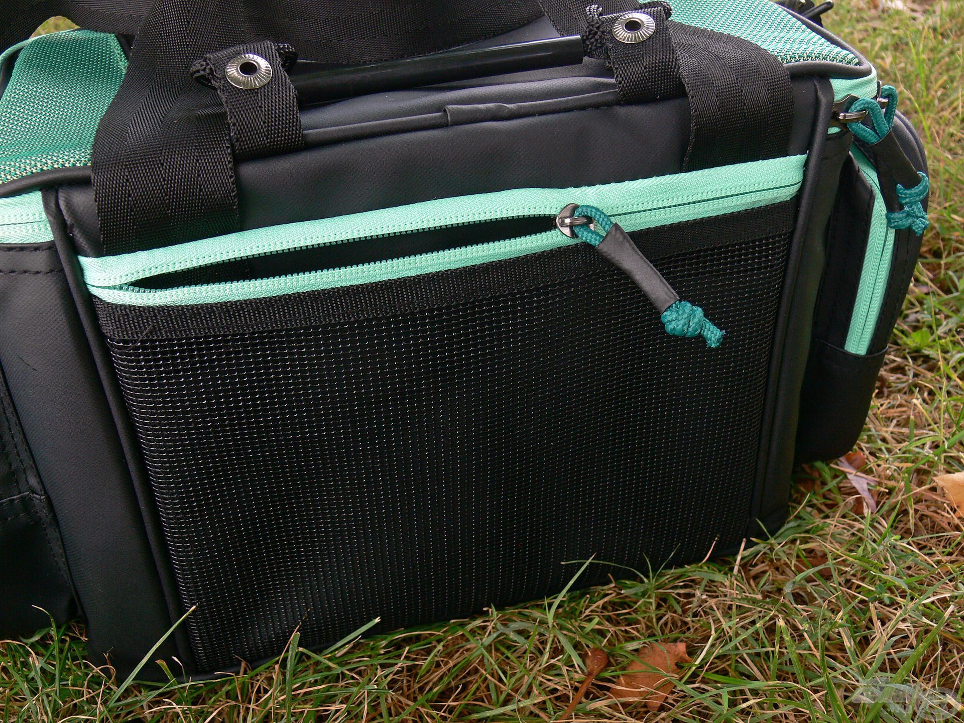 A táska hátulján van egy lapos, hálós zseb, amelybe a személyes iratok, horgászengedély, telefon vagy egyéb lapos apróság elfér